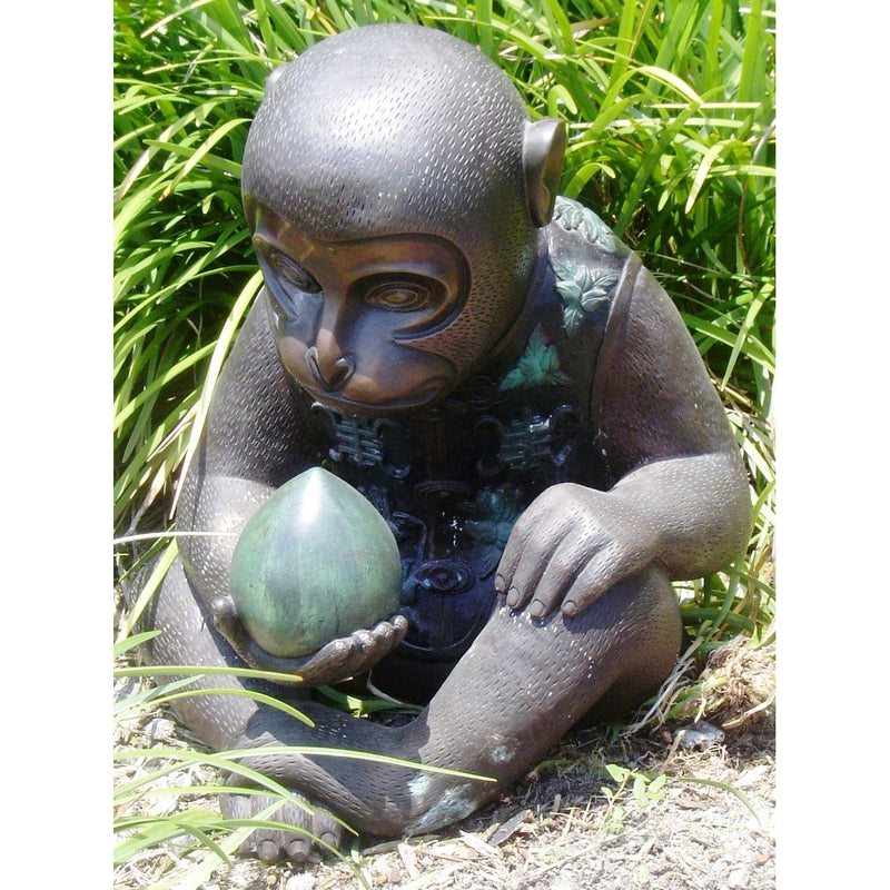 Bronze Monkey statue holding a peach