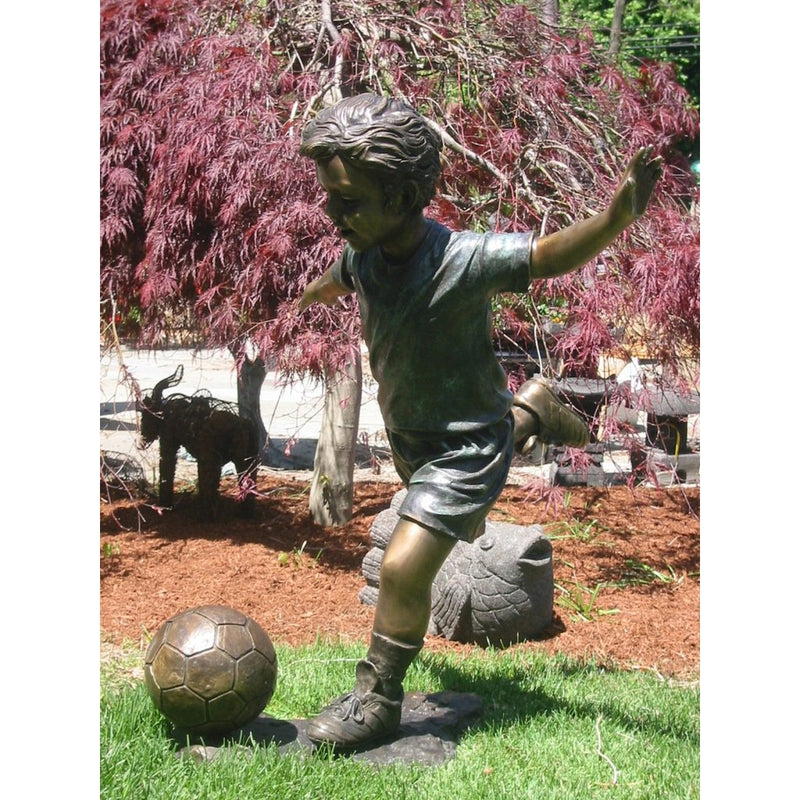 Bronze Statue of a Boy Playing Soccer