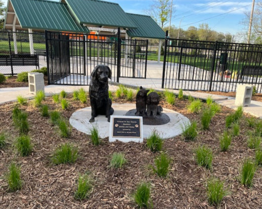 Dog Statues of Golden Retriever, Cairn Terrier and a Bichon Frise Poodle sitting together at a dog park in Illinois