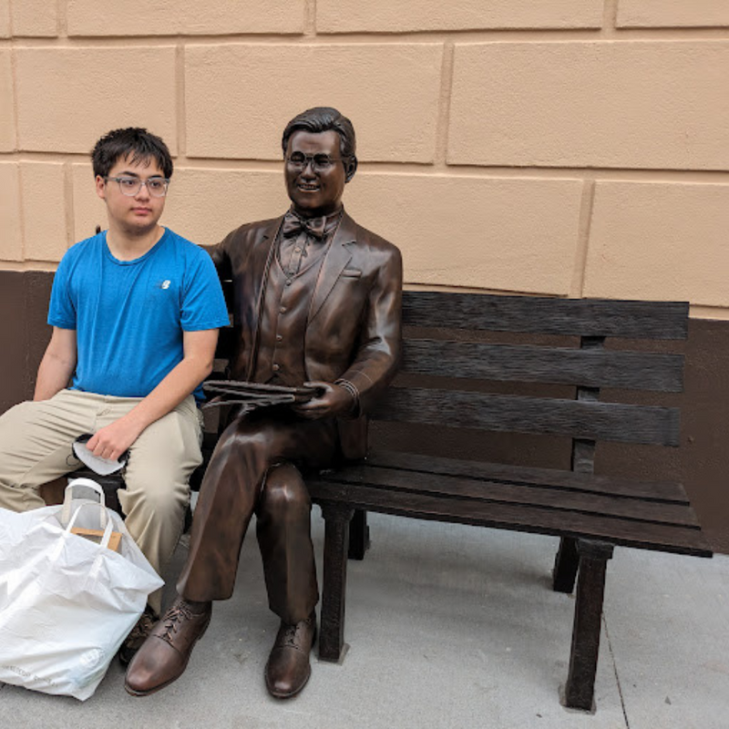 Man Sitting on Park Bench with Newspaper, Michael Yun