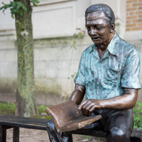 Bronze Grandfather Statue Reading on Bronze Bench