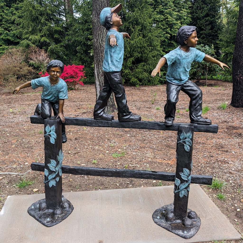 Bronze Balancing Act Trio on Fence Statue