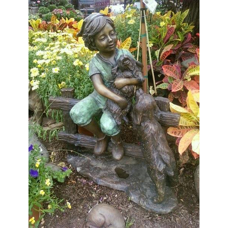 Bronze Sculpture of Child Holding Puppy Dogs on Fence