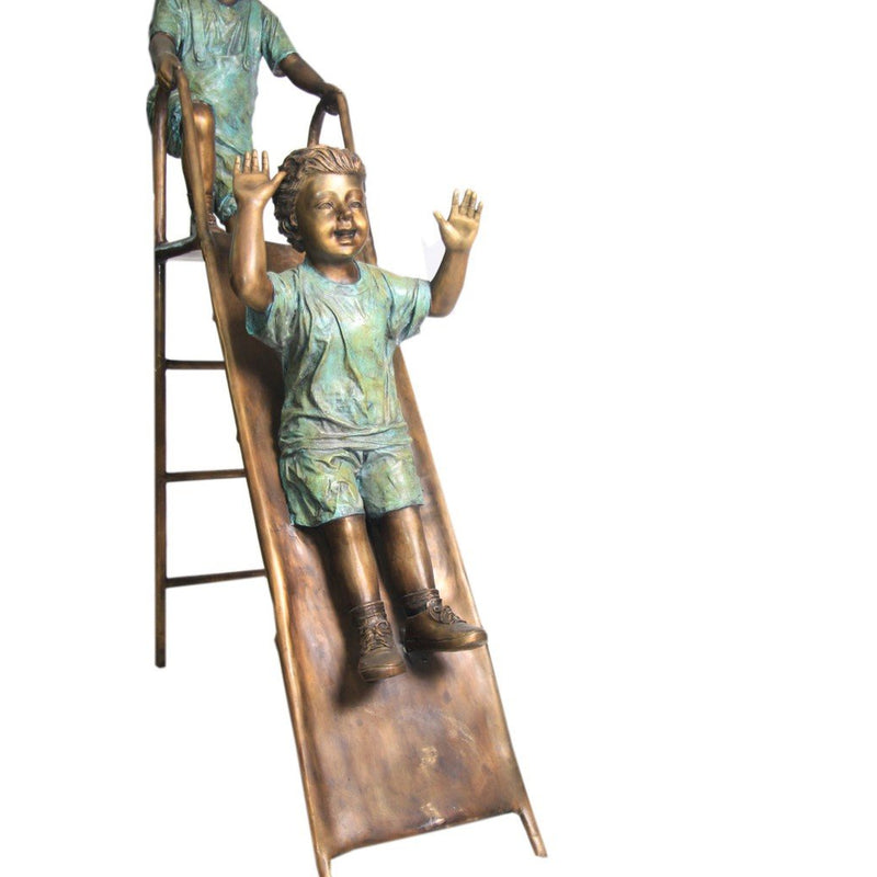 Bronze Statue of Children Playing on Slide at Park