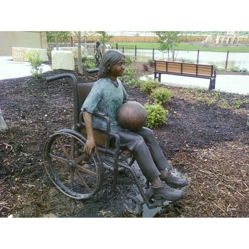 Bronze Statue of a Girl with Special Needs in a Wheelchair in a Park