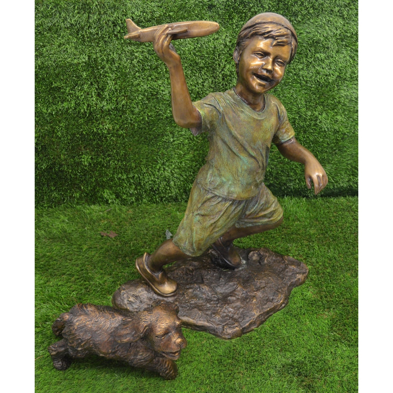 In Flight - Bronze statue of boy holding airplane