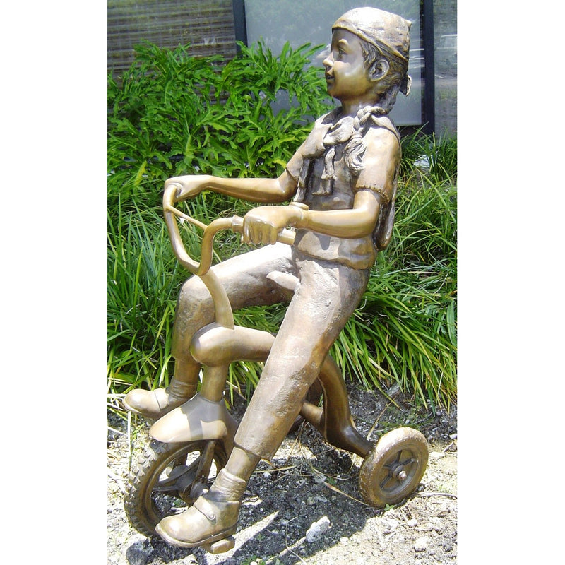 Girl Riding Tricycle Bronze Statue