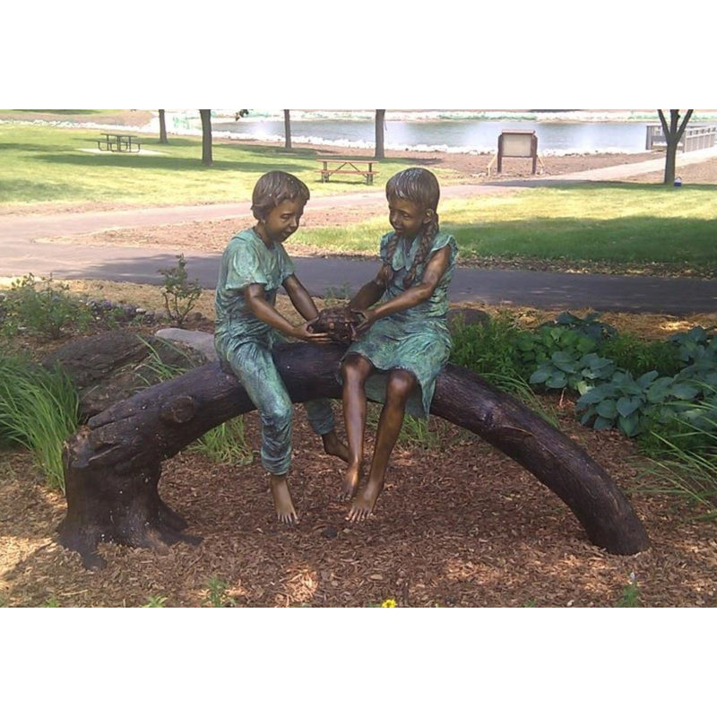 Bronze Sculpture and Fountain of Two Children Sitting on a Log Holding a Turtle 