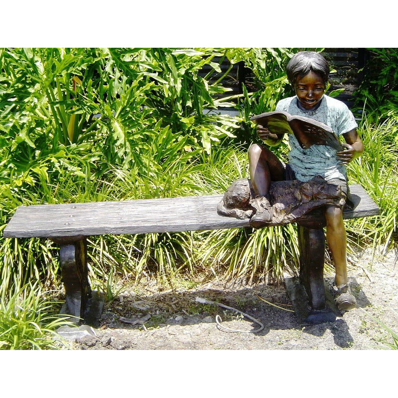 Bronze Statue of Boy Reading on a Bench with a Dog