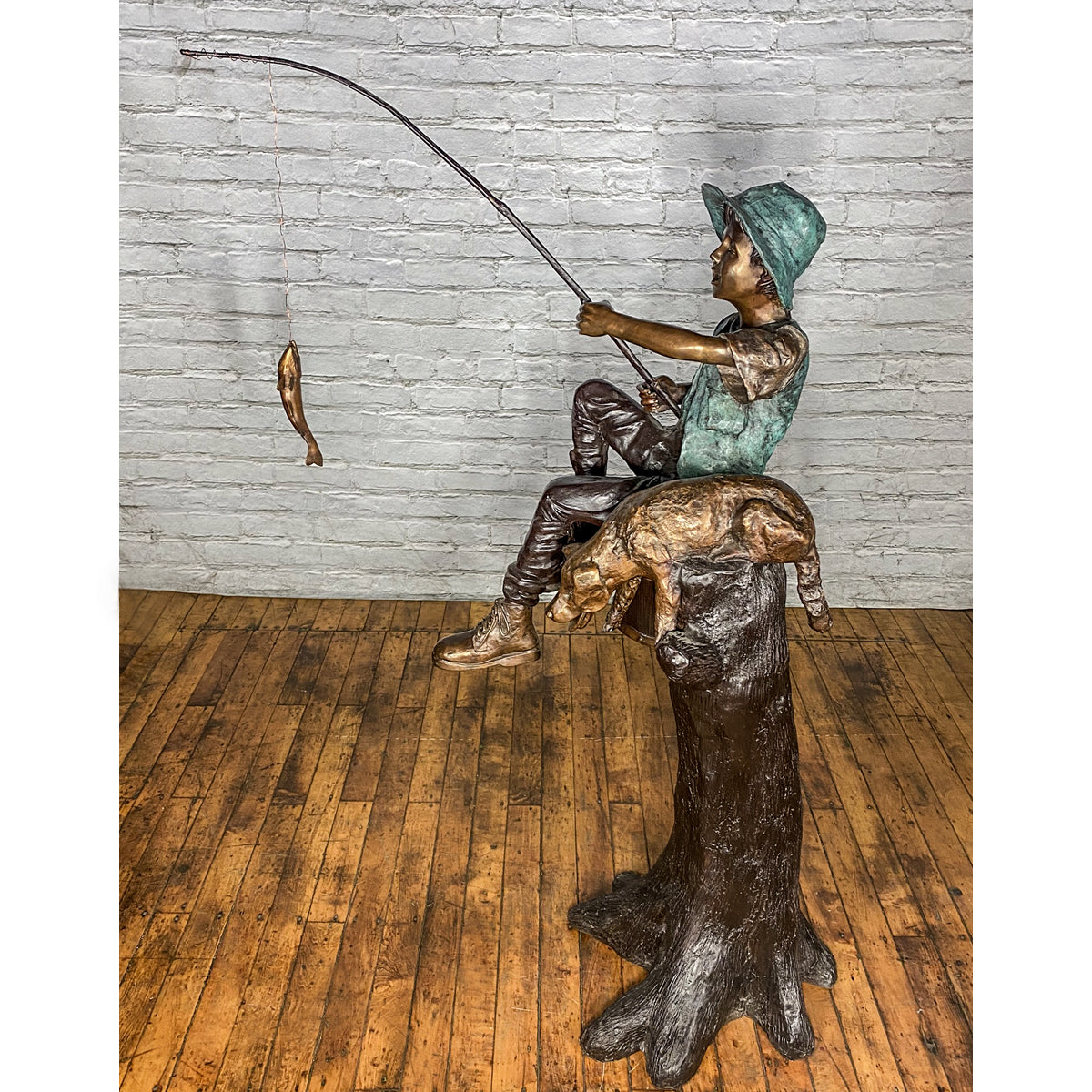 bronze child with a fishing pole Bronze Statue of a Boy Fishing With His Dog