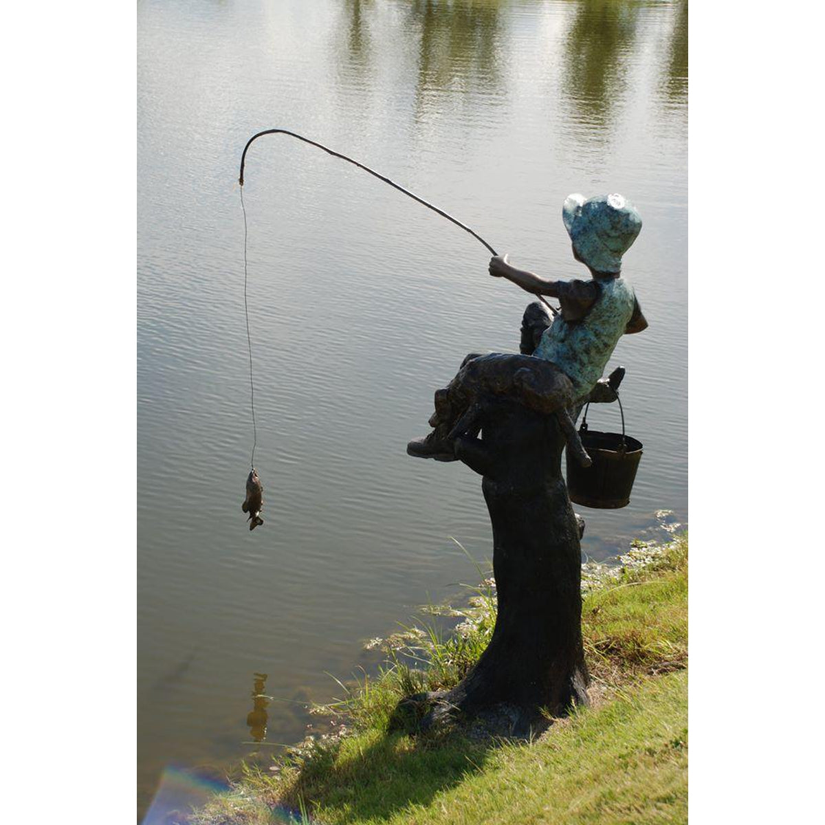 bronze child with a fishing pole Bronze Statue of a Boy Fishing With His Dog
