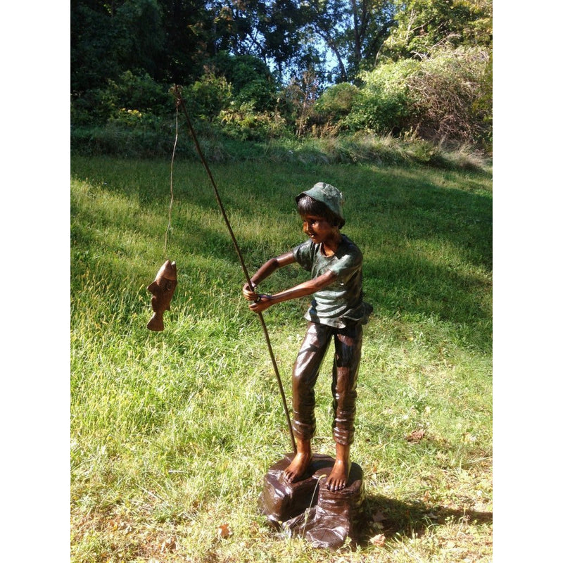 Bronze Statue of a Boy Fishing on a Rock